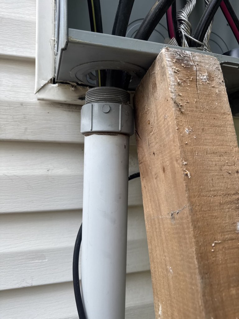 Electrical service riser conduit supported during repair